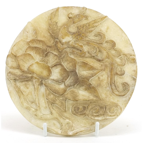 466 - Chinese circular jade disc carved with a dragon and flower, 17cm in diameter