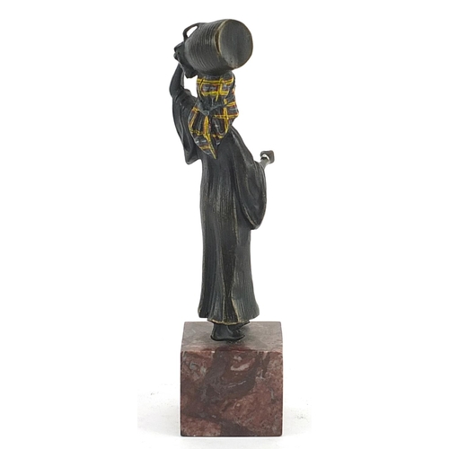 606 - Cold painted bronze figurine of an African water carrier in the style of Franz Xaver Bergmann, raise... 