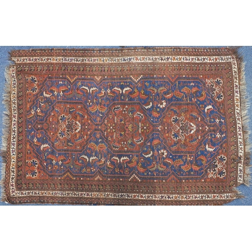 740 - Rectangular red and blue ground rug having an all over geometric design, 165cm x 120cm