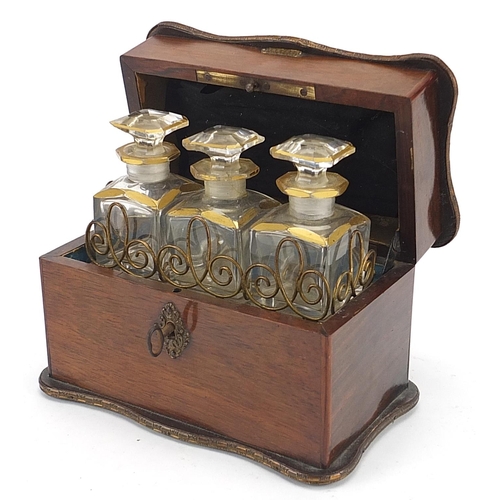 21 - 19th century rosewood mechanical action box housing three cut glass scent bottles with Brevete S. Gl... 