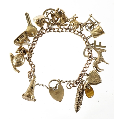 1411 - 9ct gold charm bracelet with a collection of mostly 9ct gold charms, 49.0g