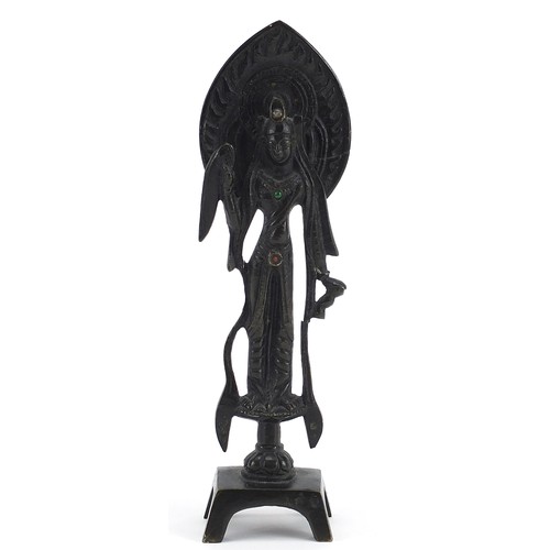 381 - Chino Tibetan patinated bronze deity, calligraphy to the reverse, 21cm high