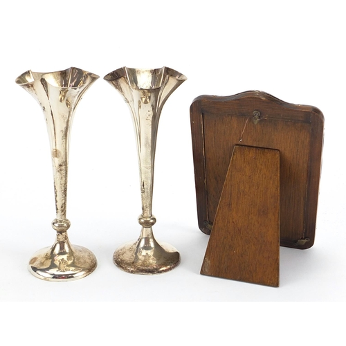 2135 - Silver items comprising pair of Mappin & Webb bud vases, easel photo frame and circular ashtray, the... 