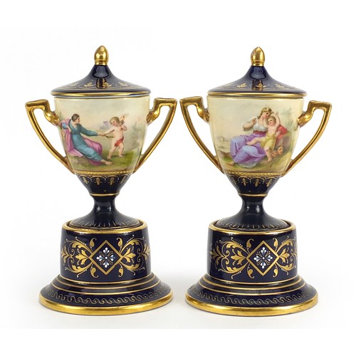 347 - Pair of Royal Vienna porcelain pedestal vases and covers with twin handles, each hand painted with c... 