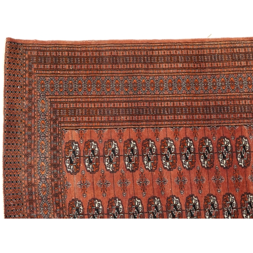 806 - Rectangular Bokhara red ground rug having an all over geometric design, 180cm x 128cm