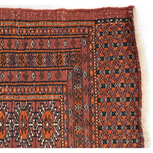 806 - Rectangular Bokhara red ground rug having an all over geometric design, 180cm x 128cm