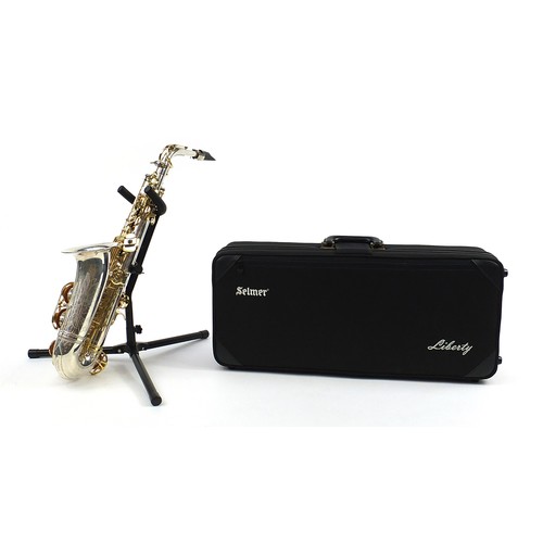 398 - Liberty by Selmer chrome plated and brass alto saxophone with protective carry case and stand, numbe... 