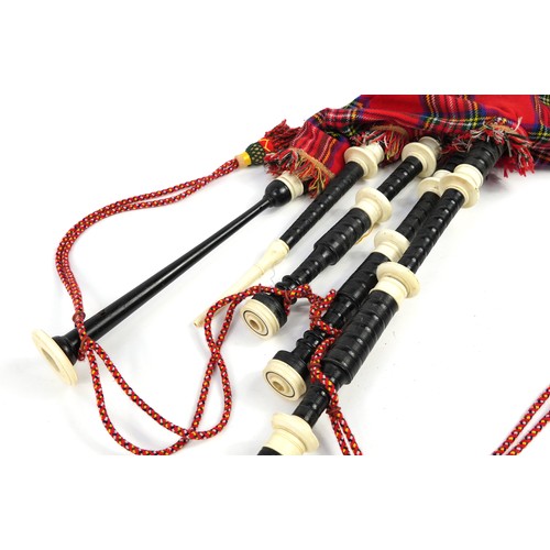 397 - Set of Scottish bagpipes with two kilts and a suit