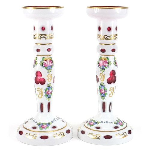 183 - Attributed to Moser, pair of Bohemian white overlaid cranberry glass candle holders, hand painted wi... 