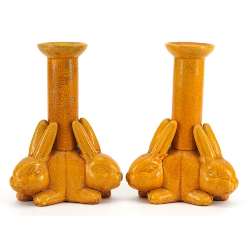 128 - Manner of Christopher Dresser, pair of Arts & Crafts yellow glazed candlesticks with three rabbits, ... 