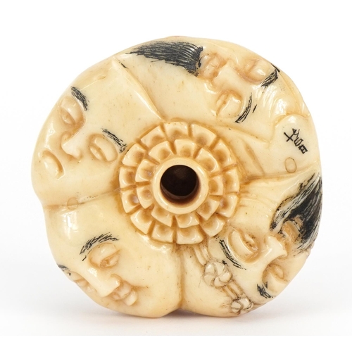 741 - Japanese bone ojime carved with theatrical faces, 4cm in diameter