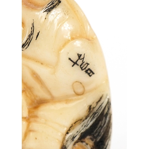 741 - Japanese bone ojime carved with theatrical faces, 4cm in diameter