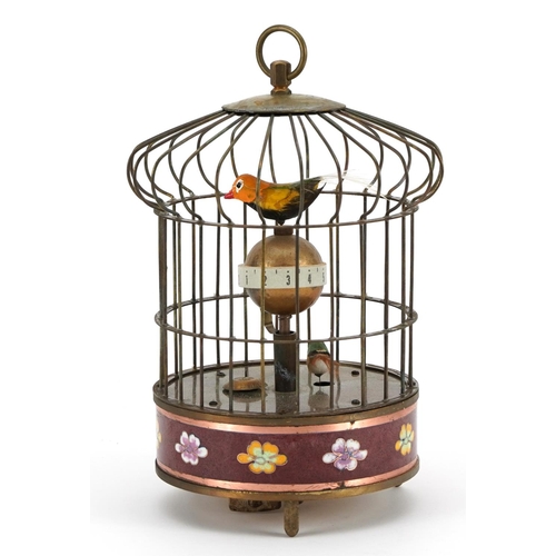 613 - Brass and cloisonne clockwork automaton birdcage with alarm clock, 19.5cm high