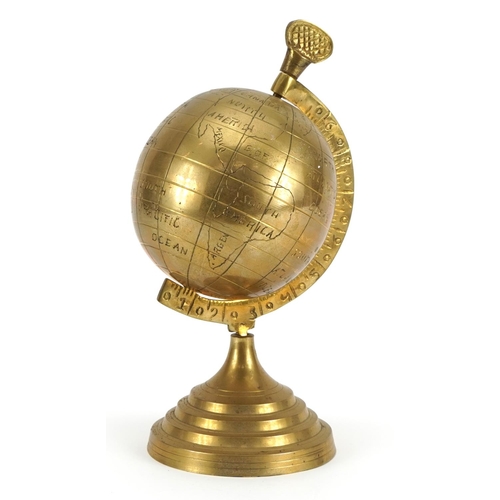 1047 - Brass rotating desk globe on stepped base, 23cm high