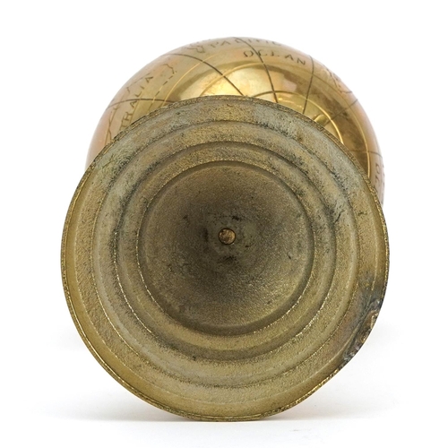 1047 - Brass rotating desk globe on stepped base, 23cm high