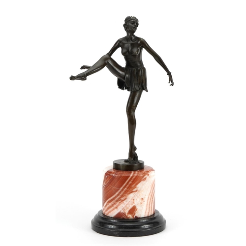 695 - Large patinated bronze figurine of an Art Deco dancer raised on a circular marble and black slate ba... 