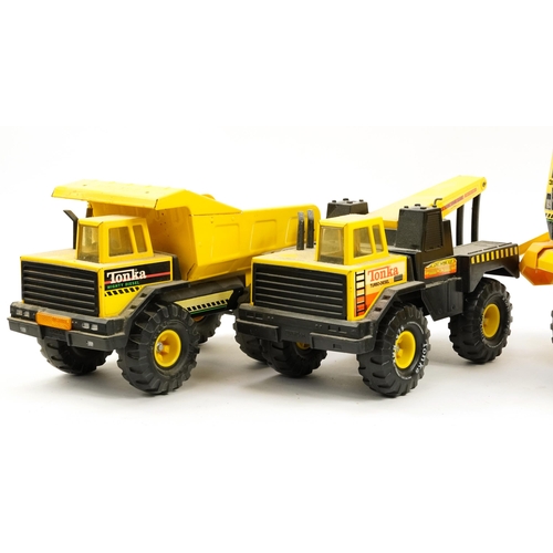 1566 - Four Tonka construction vehicles including cement mixer and dumper truck, the largest 54cm in length