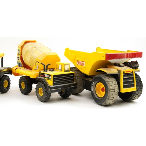 1566 - Four Tonka construction vehicles including cement mixer and dumper truck, the largest 54cm in length