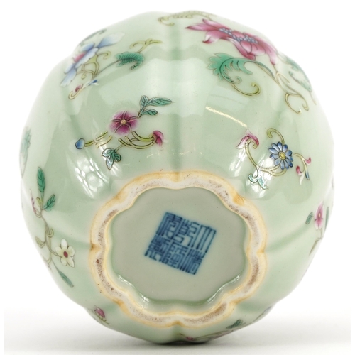 337 - Chinese porcelain vase having a celadon glaze hand painted in the famille rose palette with flowers,... 