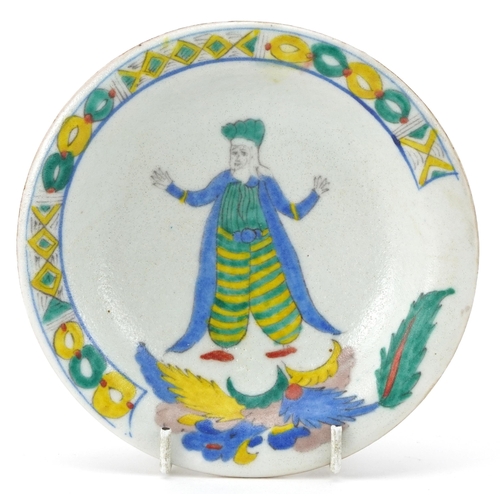 152 - Turkish Kutahya pottery shallow dish hand painted with a figure in traditional dress and leaves, 14.... 