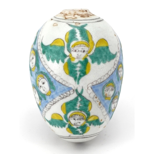 273 - Turkish Armenian pottery hanging ball hand painted with mythical faces, 10cm high