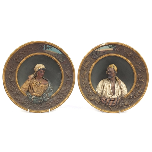 559 - Goldscheider, pair of Austrian terracotta wall plates decorated in relief with Arab busts, various i... 