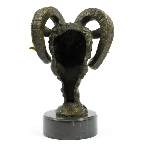 603 - Partially gilt patinated bronze bust of a ram's head raised on a circular slate base, the bronze sig... 