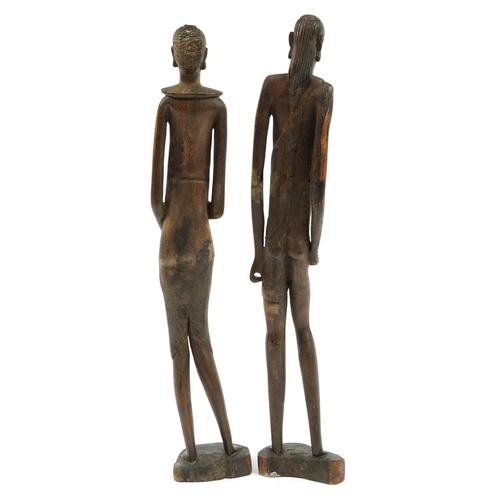 798 - Pair of West African carved wood figures of a male and female, each 59cm high