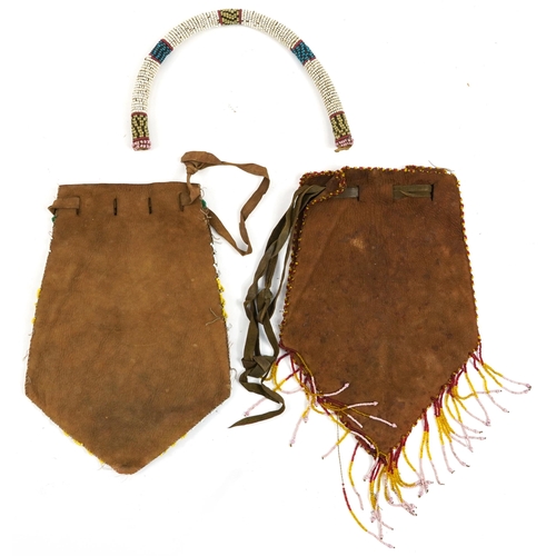 428 - Two African tribal interest leather satchels with beadwork decoration and a collar, the satchels eac... 