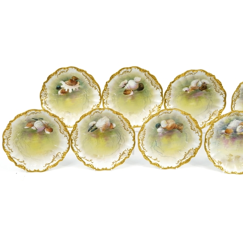 245 - Limoges, Ten French porcelain desert plates with gilt borders, each hand painted with shells and ind... 