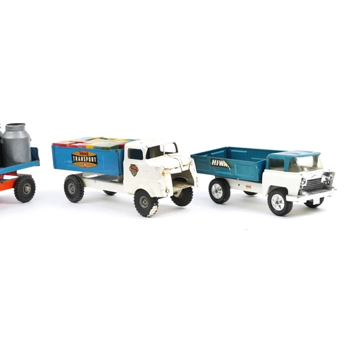 1558 - Four large vintage tinplate Tri-ang transport trucks, the largest 37cm in length