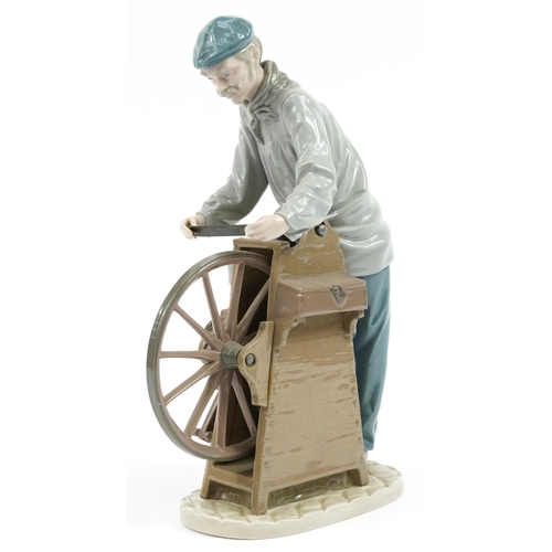 977 - Lladro porcelain figure of a man at a grinding wheel, impressed D-22A to the base, 29cm high