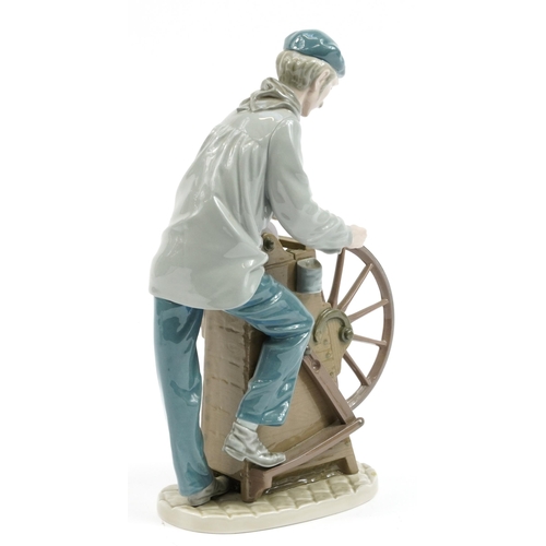 977 - Lladro porcelain figure of a man at a grinding wheel, impressed D-22A to the base, 29cm high