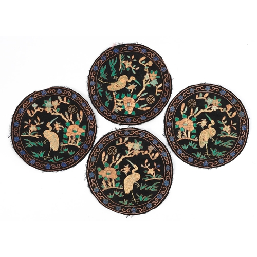 144 - Set of four Chinese textile roundels embroidered with birds of paradise amongst flowers, each 23.5cm... 