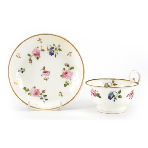 169 - Early 19th century Nantgarw cup and saucer hand painted with flowers, the cup 5cm high