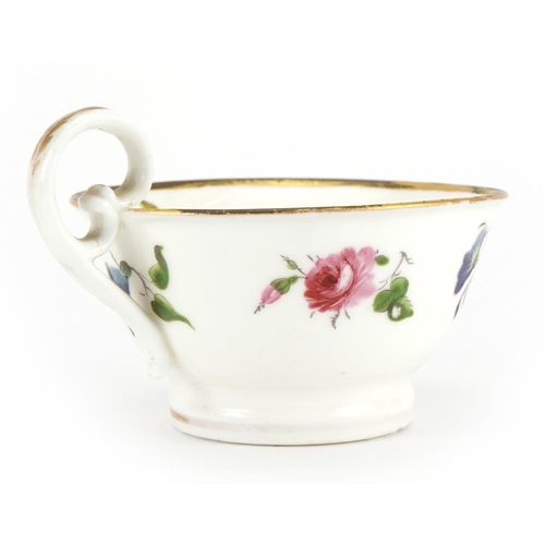 169 - Early 19th century Nantgarw cup and saucer hand painted with flowers, the cup 5cm high