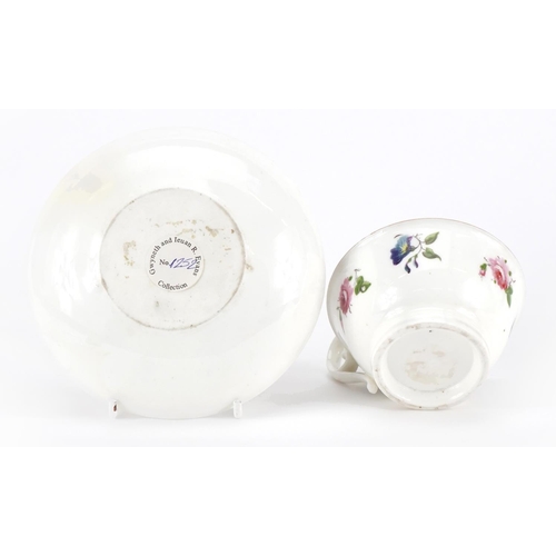 169 - Early 19th century Nantgarw cup and saucer hand painted with flowers, the cup 5cm high