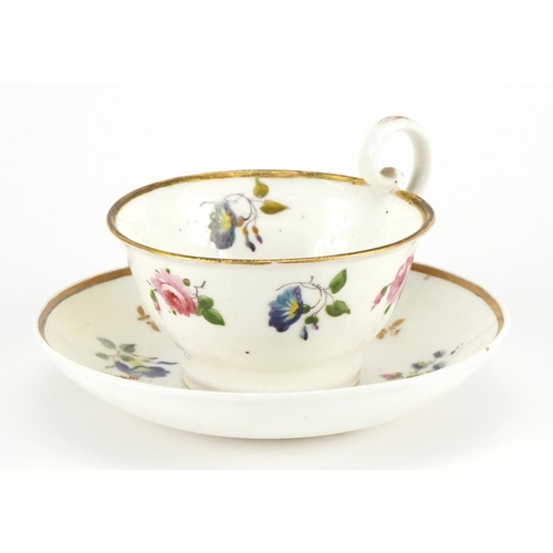 169 - Early 19th century Nantgarw cup and saucer hand painted with flowers, the cup 5cm high