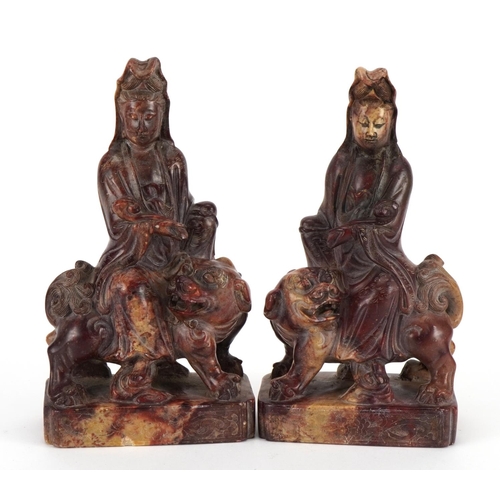 77 - Good pair of Chinese soapstone carvings of Guanyin seated on a mythical animal, each 21cm high