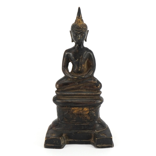 166 - South East Asian partially gilt patinated bronze figure of seated Buddha, possibly from Nepal, 21.5c... 