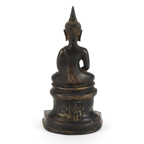 166 - South East Asian partially gilt patinated bronze figure of seated Buddha, possibly from Nepal, 21.5c... 