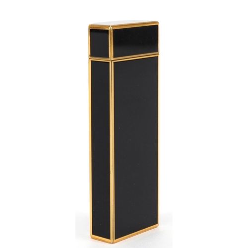 63 - Cartier gold plated and black enamel pocket lighter numbered H23649, 7cm high