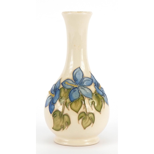 1044 - Moorcroft vase decorated in the Magnolia pattern, 16cm high