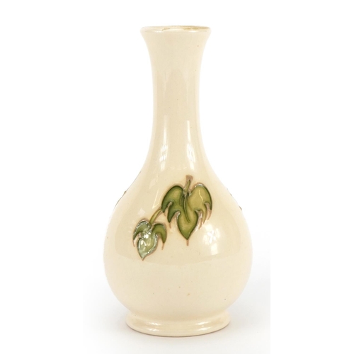 1044 - Moorcroft vase decorated in the Magnolia pattern, 16cm high