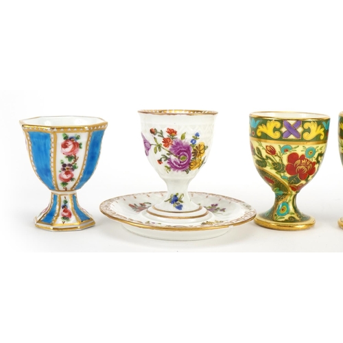 242 - Six 19th century porcelain eggcups including a pair by Dresden hand painted with flowers and one wit... 