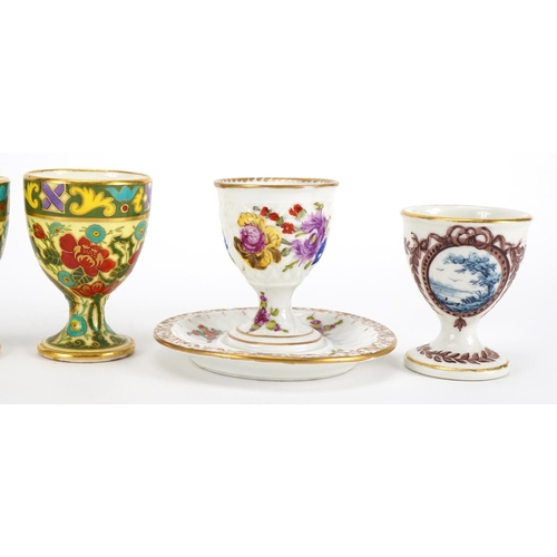 242 - Six 19th century porcelain eggcups including a pair by Dresden hand painted with flowers and one wit... 