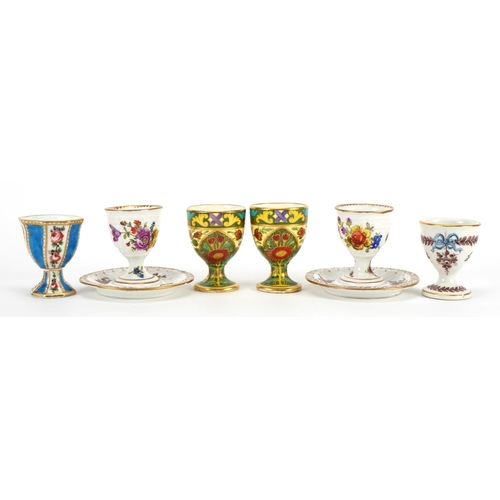 242 - Six 19th century porcelain eggcups including a pair by Dresden hand painted with flowers and one wit... 