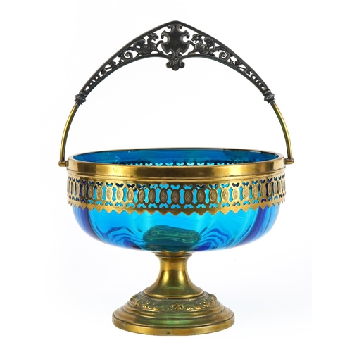 567 - WMF, Art Nouveau blue glass pedestal bowl with swing handle and metal mounts, 15.5cm high excluding ... 