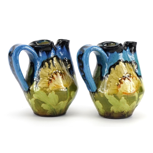 375 - RSTK, pair of continental Art Nouveau Czechoslovakian double spouted jugs hand painted with flowers,... 