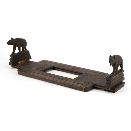 624 - Black Forest extending book slide carved with two bears, 30.5cm wide when closed